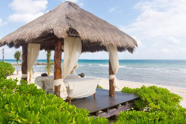 Spa services and massage booth on the beach at a luxury resort in Cancun.